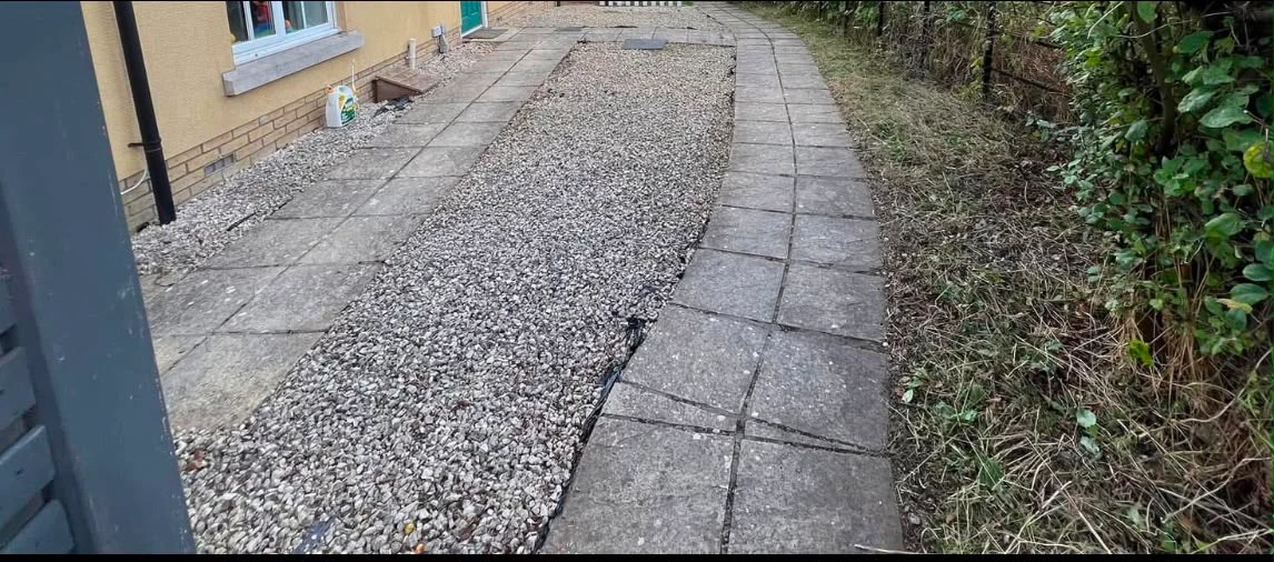 After: path cleared back to slabs and fresh gravel